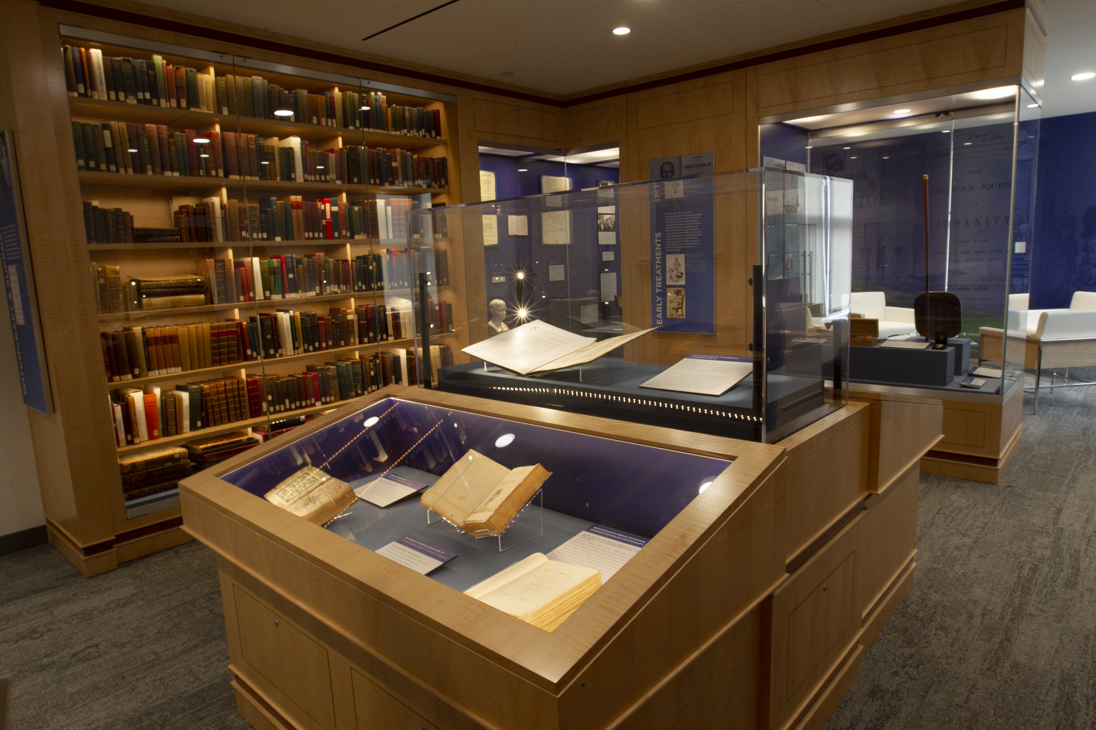 A view inside the Library and Archives showing displays of rare books and artifacts and cases of books