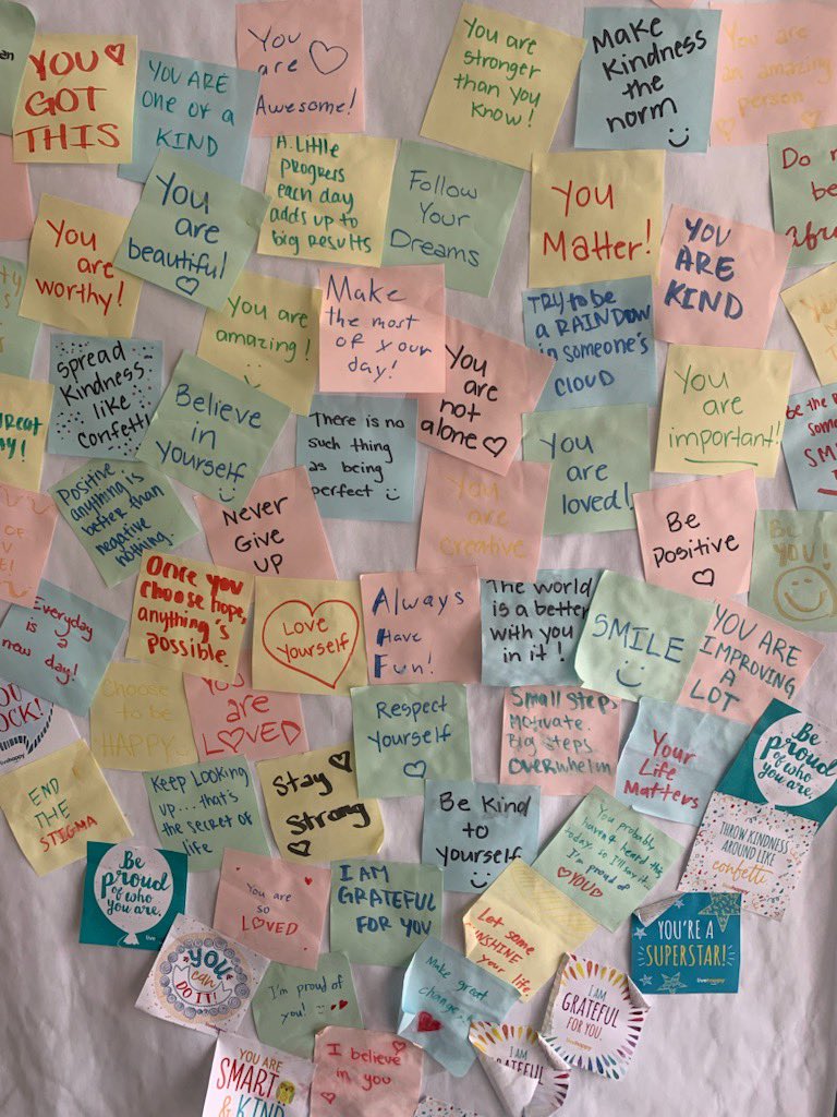 Wall of post-it notes with affirmative messages